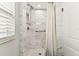 Newly remodeled shower with white and gray tiling and grab bar at 610 N Woodlynne Ave, Tampa, FL 33609