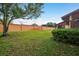 Spacious backyard features a well-maintained lawn and a sturdy perimeter fence at 7501 Greystone Dr, Hudson, FL 34667