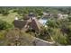 Aerial perspective of a clubhouse, swimming pool, and surrounding landscaped grounds at 7501 Greystone Dr, Hudson, FL 34667