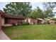 Exterior view of the property featuring lush green lawn and well maintained landscaping at 7501 Greystone Dr, Hudson, FL 34667