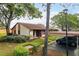 Charming home with a carport, lush landscaping, and a welcoming entrance at 7501 Greystone Dr, Hudson, FL 34667