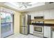 Bright kitchen features stainless steel appliances, white cabinetry, and lots of natural light at 7501 Greystone Dr, Hudson, FL 34667