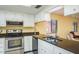 This kitchen features granite countertops, a stainless steel microwave, and a double-basin sink at 7501 Greystone Dr, Hudson, FL 34667