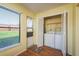 Bright laundry room features a washer, dryer, and storage with easy access to the outside at 7501 Greystone Dr, Hudson, FL 34667