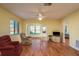 Cozy living room with wood floors, ceiling fan and lots of windows at 7501 Greystone Dr, Hudson, FL 34667