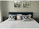 Bright bedroom with a king-sized bed and decorative mirrors above the headboard at 9007 Pebble Creek Dr # 9007, Tampa, FL 33647