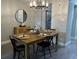 Modern dining room featuring a table with seating for four and a stylish chandelier at 9007 Pebble Creek Dr # 9007, Tampa, FL 33647