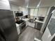 Stylish kitchen featuring stainless steel appliances, sleek white cabinetry, and a window at 9007 Pebble Creek Dr # 9007, Tampa, FL 33647