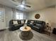 Cozy living room with a comfortable leather sectional and modern ceiling fan at 9007 Pebble Creek Dr # 9007, Tampa, FL 33647
