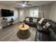 Inviting living room featuring a plush leather sectional and stylish wood-look flooring at 9007 Pebble Creek Dr # 9007, Tampa, FL 33647
