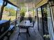 Relaxing screened-in patio with outdoor dining set, grill, and views of the lush green backyard at 9007 Pebble Creek Dr # 9007, Tampa, FL 33647