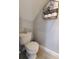 Clean powder room with white toilet and organized shelving above featuring fresh towels and toilet paper at 9007 Pebble Creek Dr # 9007, Tampa, FL 33647