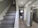 Inviting entryway featuring hardwood floors, neutral paint, and an open layout to the kitchen and living area at 9007 Pebble Creek Dr # 9007, Tampa, FL 33647