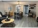 Open living room featuring stylish furniture, dining table set, and decorative brick wall with coffee bar station at 9007 Pebble Creek Dr # 9007, Tampa, FL 33647