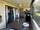 Inviting screened patio with stylish furniture, fan, and serene outdoor views, perfect for relaxation at 9007 Pebble Creek Dr # 9007, Tampa, FL 33647