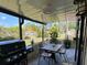 Enjoy outdoor dining on this screened patio with a table, chairs, grill, fan and tranquil views at 9007 Pebble Creek Dr # 9007, Tampa, FL 33647