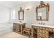 Bathroom featuring dual vanities, decorative mirrors, and a soaking tub at 1003 Berkshire Ln, Tarpon Springs, FL 34688