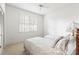 Bright bedroom featuring two twin beds and window with plantation shutters at 1003 Berkshire Ln, Tarpon Springs, FL 34688