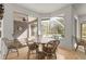 Bright dining area features a wood table and chairs, hardwood floors, and a window view to the pool at 1003 Berkshire Ln, Tarpon Springs, FL 34688