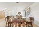 Open-concept dining room with neutral decor, plush carpet, and seamless access to the living spaces at 1003 Berkshire Ln, Tarpon Springs, FL 34688
