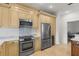 Well-equipped kitchen with stainless steel appliances, modern backsplash, and sleek light-toned cabinets at 1003 Berkshire Ln, Tarpon Springs, FL 34688
