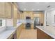 Modern kitchen with stainless steel appliances, light wood floors, light-toned cabinets and marble countertops at 1003 Berkshire Ln, Tarpon Springs, FL 34688