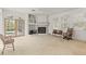 Spacious living room features fireplace, large windows with plantation shutters, and glass doors to the pool area at 1003 Berkshire Ln, Tarpon Springs, FL 34688