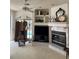 Inviting living room with a fireplace, TV, pool view through glass doors, ceiling fan, and ample natural light at 1003 Berkshire Ln, Tarpon Springs, FL 34688
