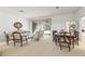 Bright living room featuring neutral decor, a dining area, and seamless access to the screened lanai at 1003 Berkshire Ln, Tarpon Springs, FL 34688