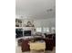Spacious living room with a fireplace, built-in shelves, large windows, and comfortable brown leather seating at 1003 Berkshire Ln, Tarpon Springs, FL 34688