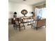 Bright living room featuring elegant furniture and decor with access to an outdoor balcony with water views at 1003 Berkshire Ln, Tarpon Springs, FL 34688