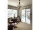 Sitting room with floral print window treatments, an ornate chandelier and views of the pool and outdoor patio at 1003 Berkshire Ln, Tarpon Springs, FL 34688
