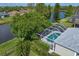 Aerial view of the screened-in pool and lush backyard backing onto a serene lake at 10339 Lightner Bridge Dr, Tampa, FL 33626