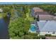 Aerial view showcasing the serene lake and private screened-in pool areas of adjacent properties at 10339 Lightner Bridge Dr, Tampa, FL 33626