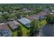 Backyard aerial view of a home with an in-ground screened pool overlooking a tranquil lake at 10339 Lightner Bridge Dr, Tampa, FL 33626