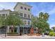Exterior view of West Park Village Luxury Apartments and Blind Tiger Coffee with outdoor seating at 10339 Lightner Bridge Dr, Tampa, FL 33626