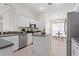 Well-lit kitchen featuring modern appliances, island, and adjacent dining area at 10339 Lightner Bridge Dr, Tampa, FL 33626