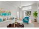 Comfortable living room with stylish blue accents, ceiling fan, sliding doors to outdoor patio and pool at 10339 Lightner Bridge Dr, Tampa, FL 33626