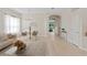 Open-concept living and dining area with neutral colors, light wood floors, and arched doorways creates a bright atmosphere at 10339 Lightner Bridge Dr, Tampa, FL 33626