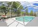 Screened-in pool area, perfect for outdoor relaxation and entertaining by the pond at 10339 Lightner Bridge Dr, Tampa, FL 33626