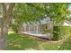 Private screened-in pool surrounded by lush landscaping and a well-maintained lawn at 10339 Lightner Bridge Dr, Tampa, FL 33626