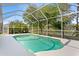 Backyard pool with screened-in enclosure featuring waterfront views at 10339 Lightner Bridge Dr, Tampa, FL 33626