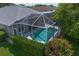 Aerial view of the screened-in pool area, surrounded by lush landscaping and well-maintained garden at 10339 Lightner Bridge Dr, Tampa, FL 33626