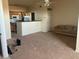 Open-concept living space with kitchen, living area, and neutral carpet at 10764 70Th Ave # 4302, Seminole, FL 33772