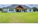 Expansive backyard and covered patio create a serene outdoor living space at 111 Alafia Estates Ln, Plant City, FL 33567