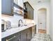 Stylish bar area with dark cabinetry, marble countertops, and elegant fixtures at 111 Alafia Estates Ln, Plant City, FL 33567