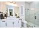 Bright bathroom featuring a glass shower, decorative tile flooring, and a modern vanity at 111 Alafia Estates Ln, Plant City, FL 33567