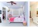 Comfortable bedroom featuring a unique egg chair, en suite bathroom, and walk-in closet access at 111 Alafia Estates Ln, Plant City, FL 33567