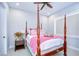 Bedroom with a four-poster bed, neutral walls, and gray carpet at 111 Alafia Estates Ln, Plant City, FL 33567