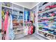 Spacious walk-in closet with custom shelving for shoes, folded clothes, and hanging garments at 111 Alafia Estates Ln, Plant City, FL 33567